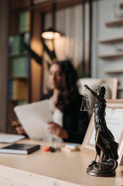 figurine-of-justice-on-table-in-office